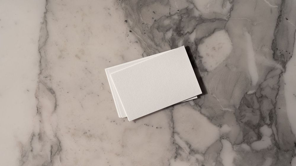 Boutique hospitality rebrand collateral on marble surface